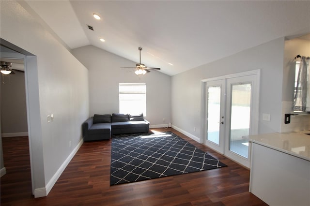 living room with baseboards, wood finished floors, a ceiling fan, and vaulted ceiling