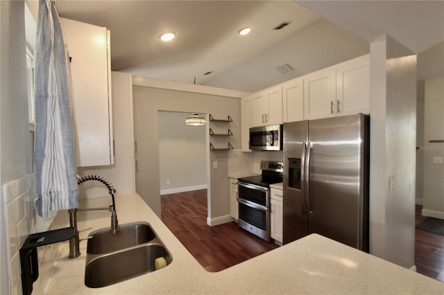 kitchen with visible vents, a sink, open shelves, white cabinetry, and stainless steel appliances