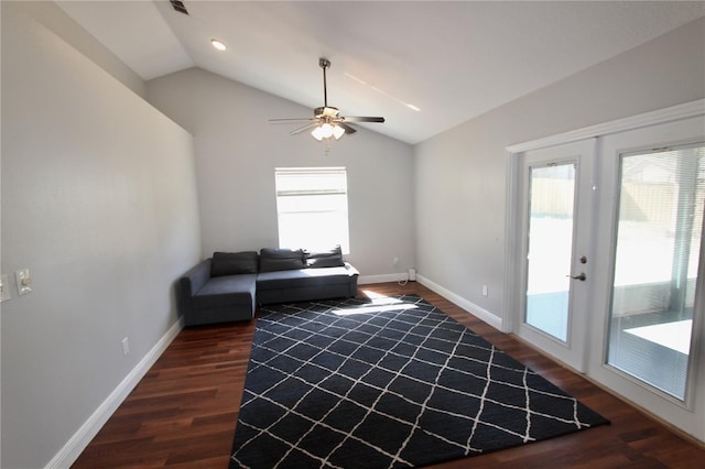 unfurnished room featuring dark wood finished floors, lofted ceiling, baseboards, and ceiling fan