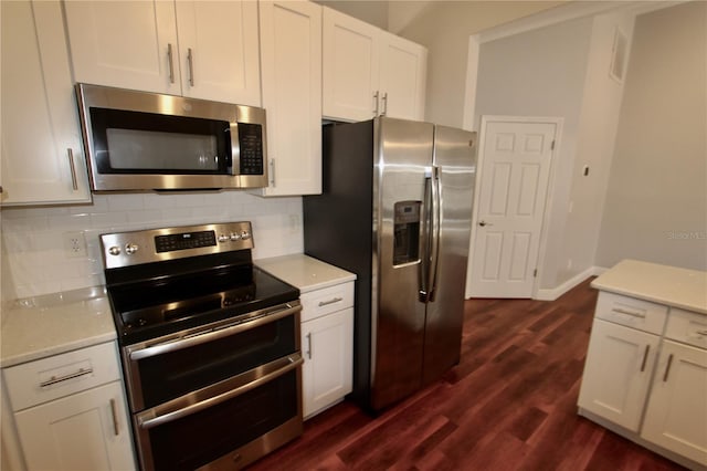 kitchen featuring tasteful backsplash, dark wood finished floors, appliances with stainless steel finishes, and light countertops