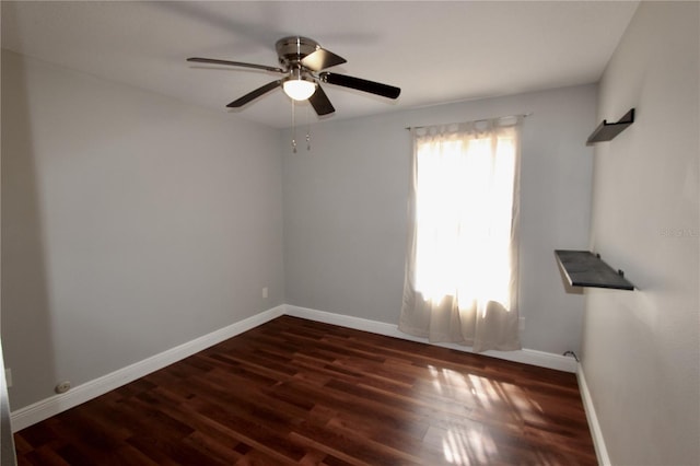 empty room featuring ceiling fan, baseboards, and wood finished floors