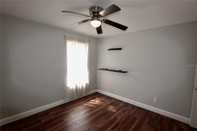 unfurnished room with ceiling fan, dark wood-type flooring, and baseboards