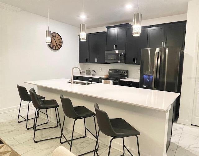 kitchen featuring a sink, light countertops, marble finish floor, appliances with stainless steel finishes, and dark cabinets