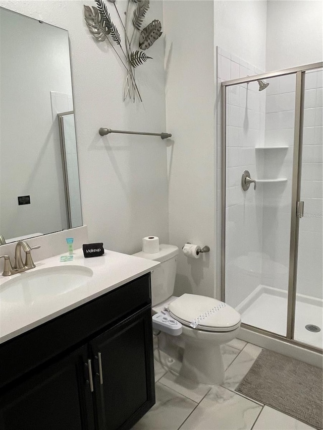 full bathroom with vanity, a shower stall, toilet, and marble finish floor