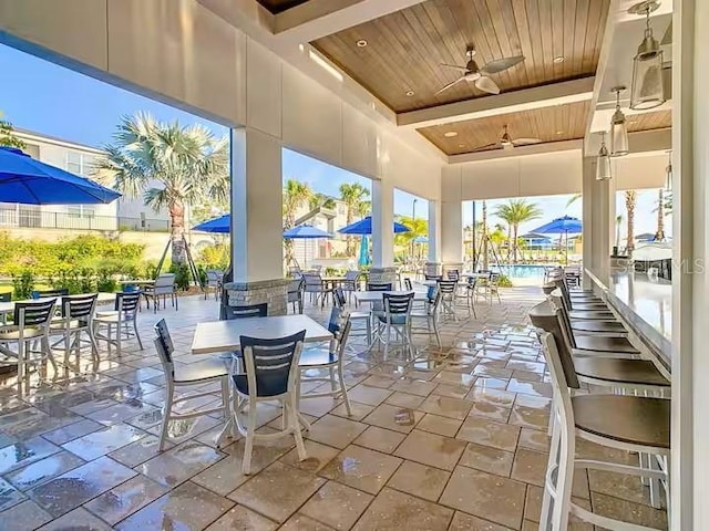 view of patio with outdoor dining area and ceiling fan