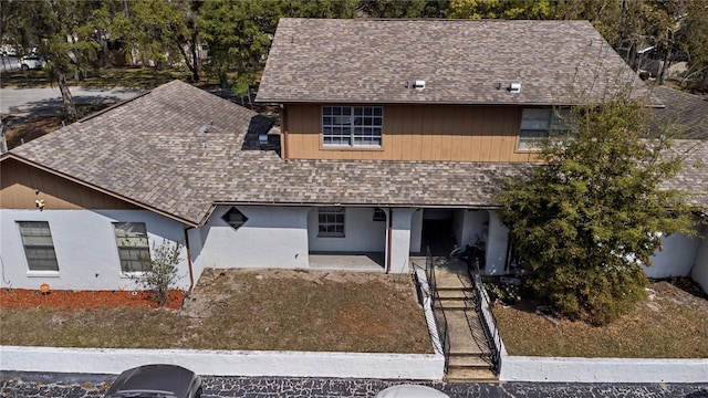 view of front facade with roof with shingles