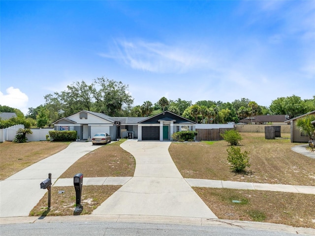 view of front facade featuring driveway and fence