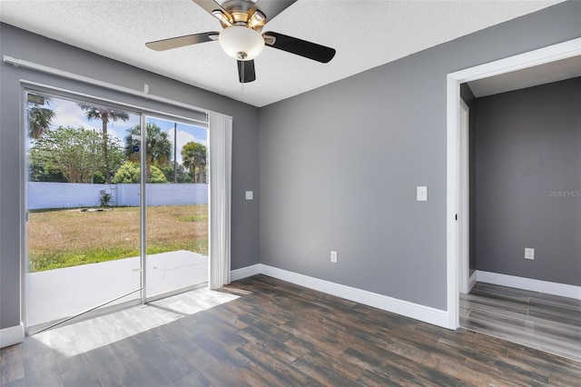 empty room featuring ceiling fan, a textured ceiling, baseboards, and wood finished floors