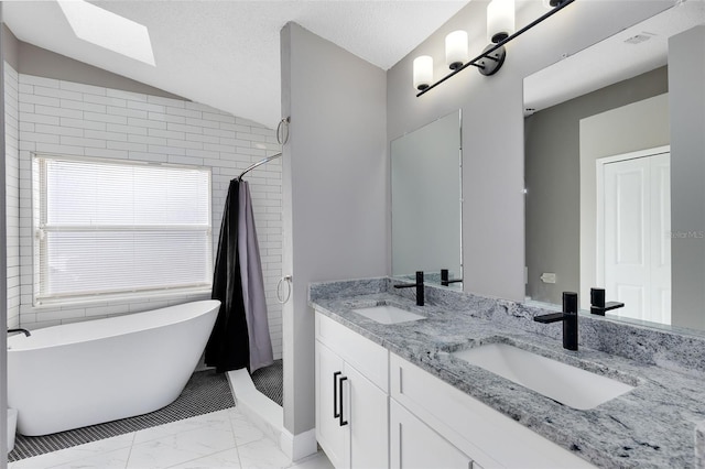 full bathroom with vaulted ceiling, marble finish floor, a shower with curtain, and a sink