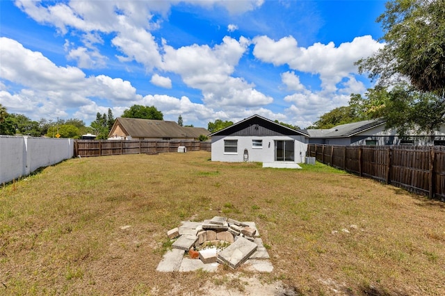 view of yard with a fenced backyard and an outdoor fire pit