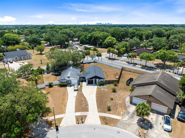 birds eye view of property with a view of trees