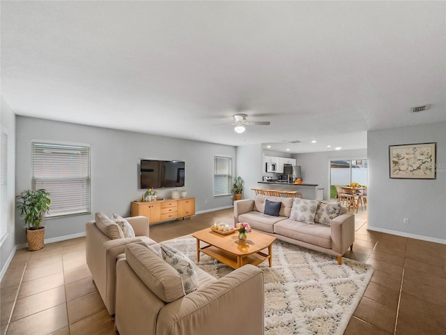 living area featuring visible vents, recessed lighting, tile patterned flooring, baseboards, and ceiling fan