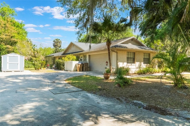 ranch-style house with driveway, an outdoor structure, a storage shed, and a garage