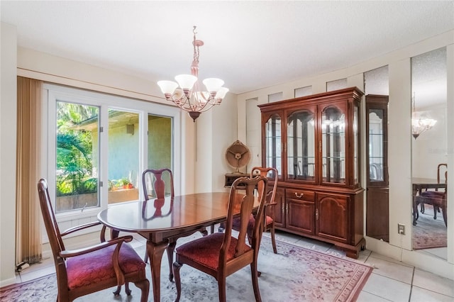 dining area featuring plenty of natural light, light tile patterned flooring, and a chandelier