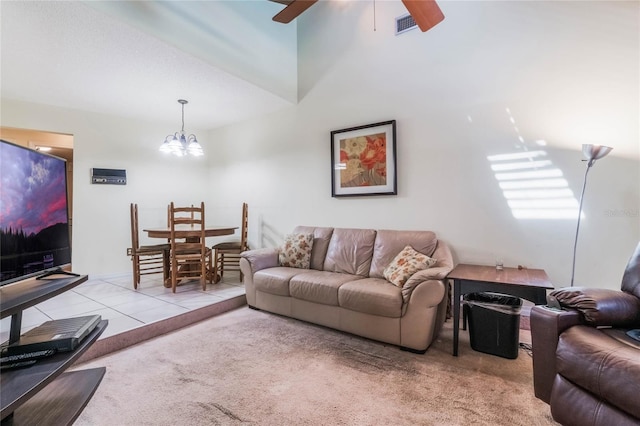 living room featuring visible vents, carpet floors, tile patterned flooring, and ceiling fan with notable chandelier