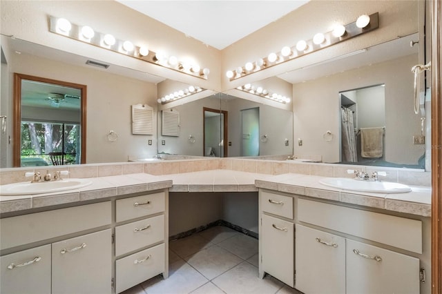 bathroom with a sink, visible vents, two vanities, and tile patterned floors