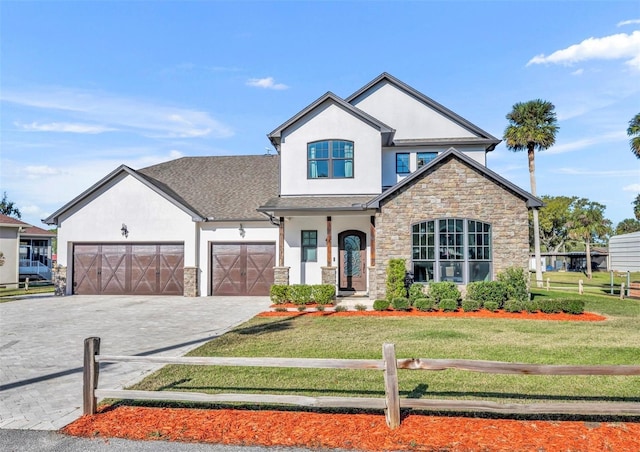 view of front of property with a front lawn, an attached garage, driveway, and stucco siding