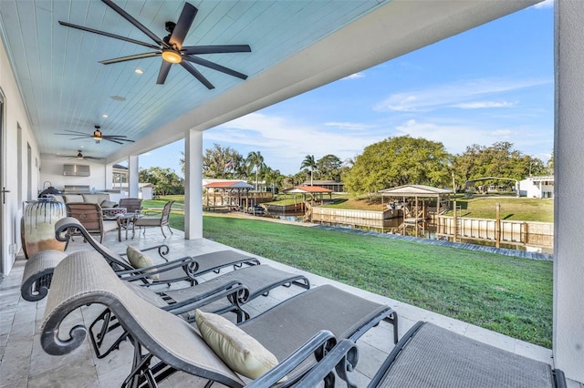 view of patio featuring a boat dock and a ceiling fan