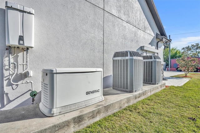 details with tankless water heater, central air condition unit, stucco siding, and a power unit