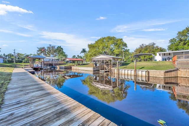 dock area with a yard, a water view, and boat lift