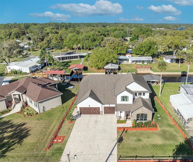 drone / aerial view featuring a forest view and a residential view