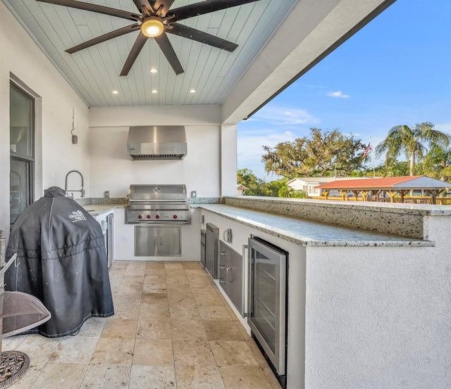 view of patio with ceiling fan, wine cooler, area for grilling, a grill, and a sink