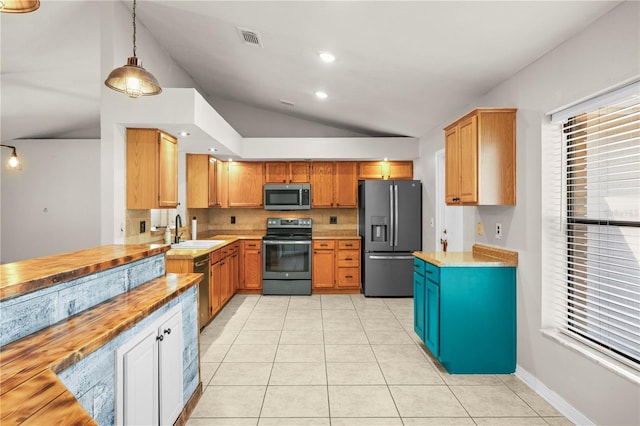 kitchen featuring visible vents, lofted ceiling, light tile patterned flooring, a sink, and stainless steel appliances