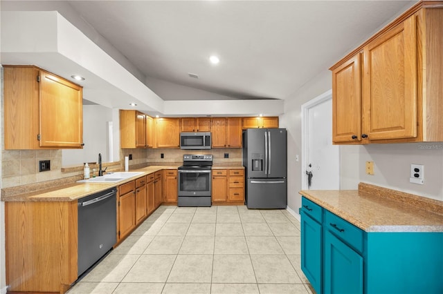 kitchen featuring a sink, stainless steel appliances, light tile patterned floors, decorative backsplash, and lofted ceiling