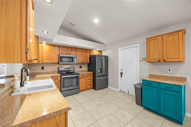 kitchen featuring visible vents, a sink, stainless steel appliances, light countertops, and lofted ceiling