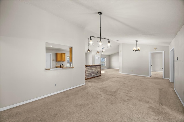 unfurnished living room featuring lofted ceiling, a notable chandelier, light colored carpet, and baseboards