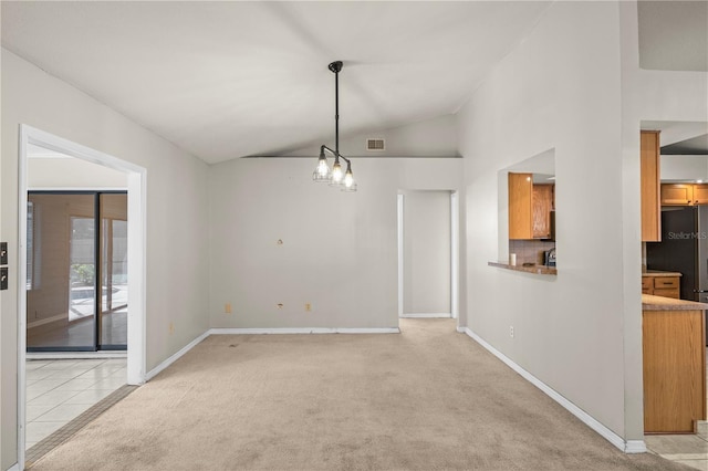 unfurnished dining area with visible vents, high vaulted ceiling, an inviting chandelier, baseboards, and light colored carpet