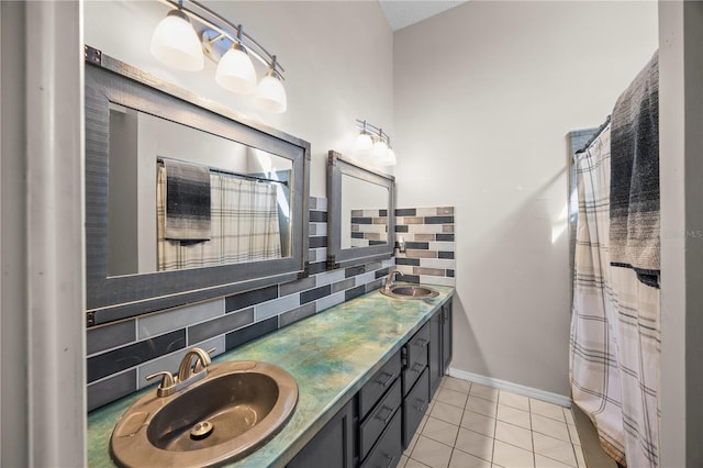 bathroom with a sink, backsplash, double vanity, and tile patterned flooring