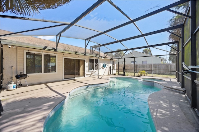 view of pool with a patio, fence, a lanai, and a pool with connected hot tub