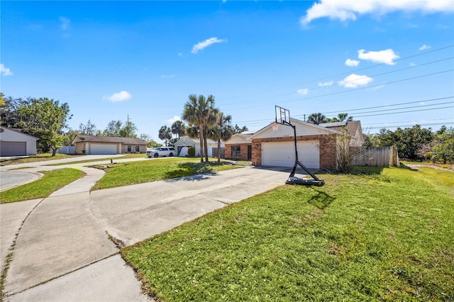 single story home featuring a garage, concrete driveway, and a front yard