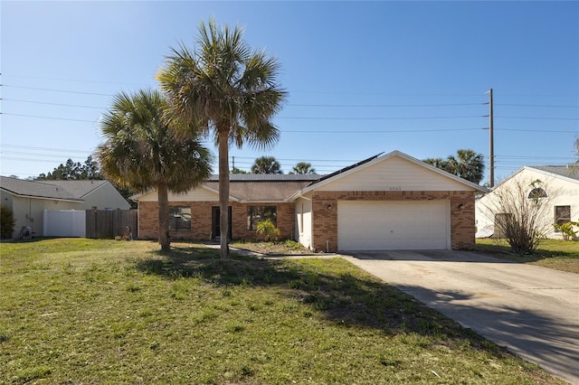 ranch-style house featuring a front lawn, driveway, fence, a garage, and brick siding