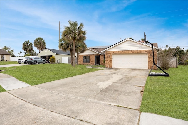 ranch-style home featuring a front yard, concrete driveway, brick siding, and an attached garage