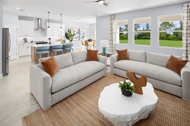 living area with a wealth of natural light, ceiling fan, and recessed lighting