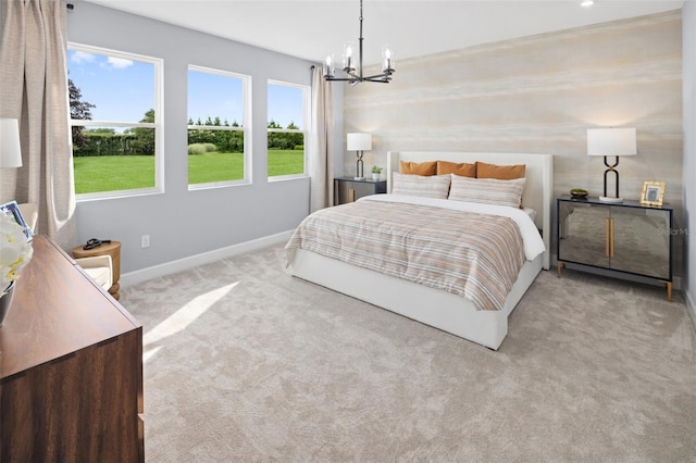 carpeted bedroom with baseboards and a chandelier