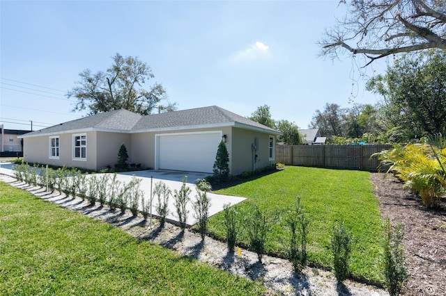 view of property exterior with stucco siding, fence, a yard, concrete driveway, and a garage