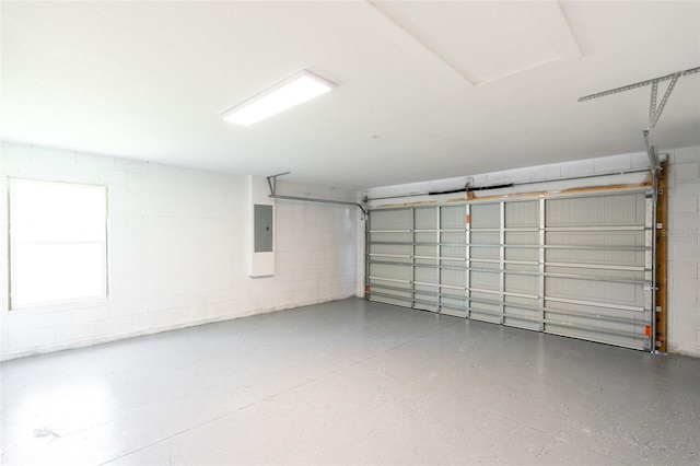 garage with concrete block wall and electric panel