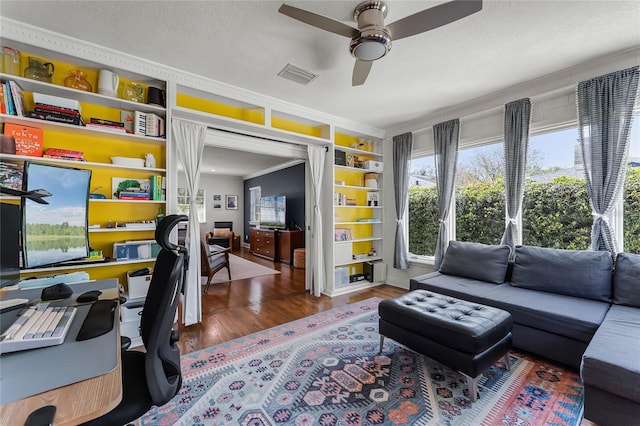 office featuring ceiling fan, visible vents, a textured ceiling, and wood finished floors