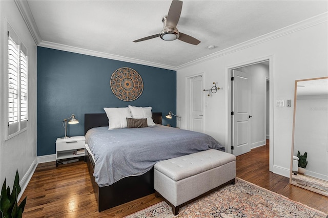 bedroom with wood finished floors, baseboards, and ornamental molding