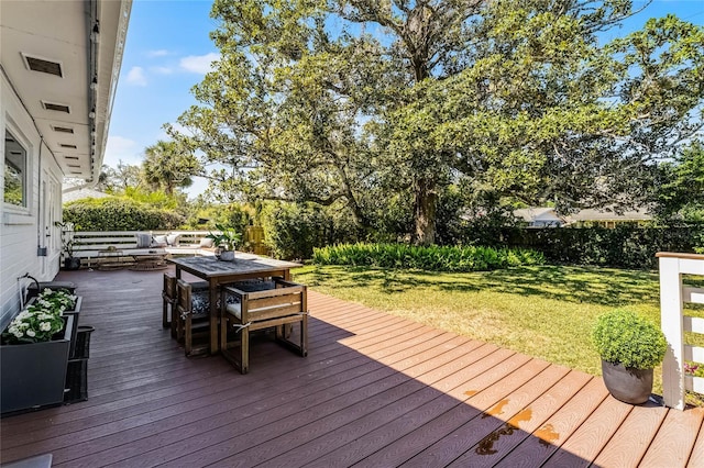 wooden deck featuring outdoor dining area, a yard, and an outdoor hangout area