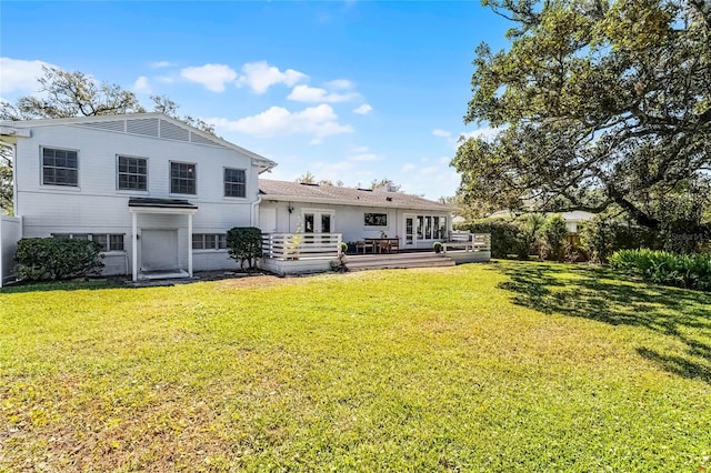 rear view of property featuring french doors, a yard, and fence