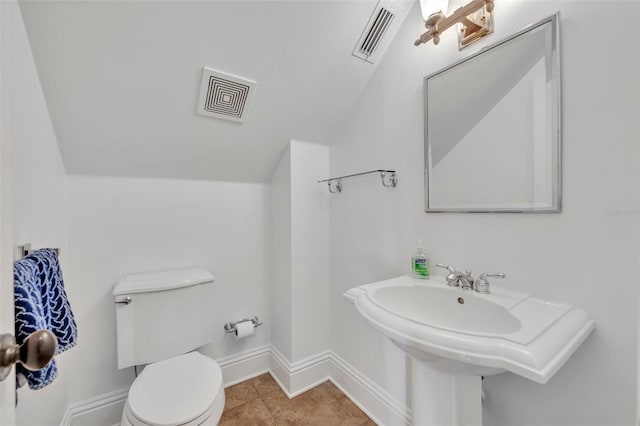 bathroom featuring tile patterned flooring, visible vents, toilet, and baseboards