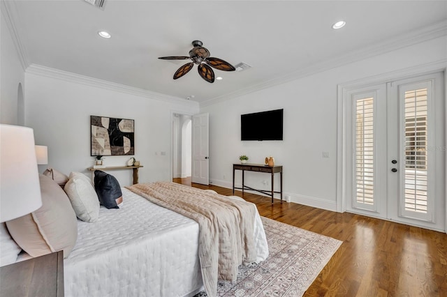 bedroom with baseboards, wood finished floors, ornamental molding, and access to outside