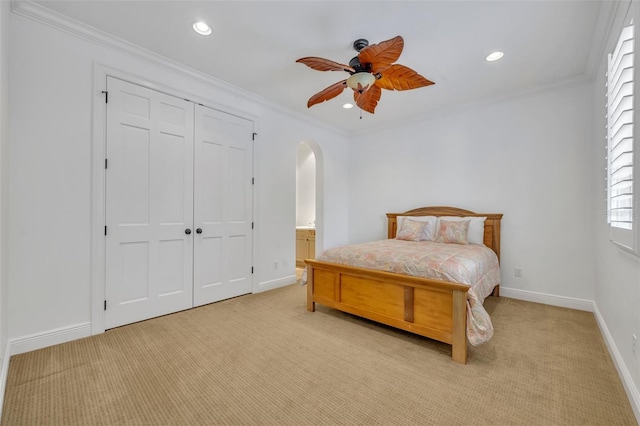 bedroom featuring recessed lighting, arched walkways, light colored carpet, and crown molding