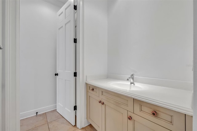 bathroom featuring vanity, tile patterned floors, and baseboards