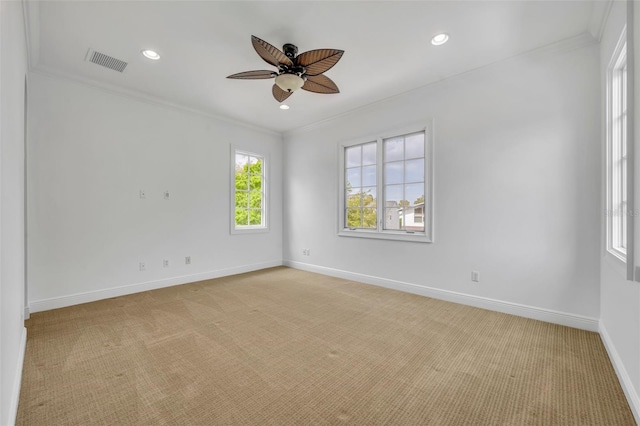 unfurnished room featuring visible vents, ceiling fan, baseboards, ornamental molding, and light carpet