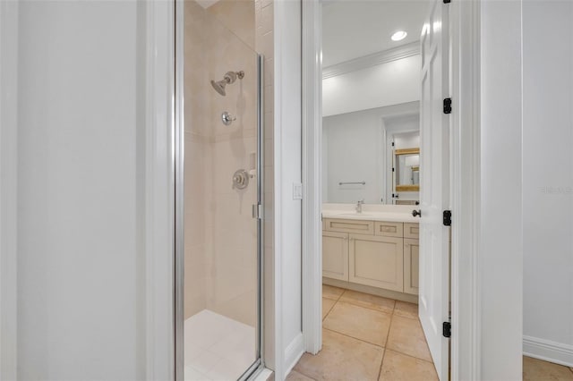 full bathroom with tile patterned floors, a shower stall, vanity, and baseboards